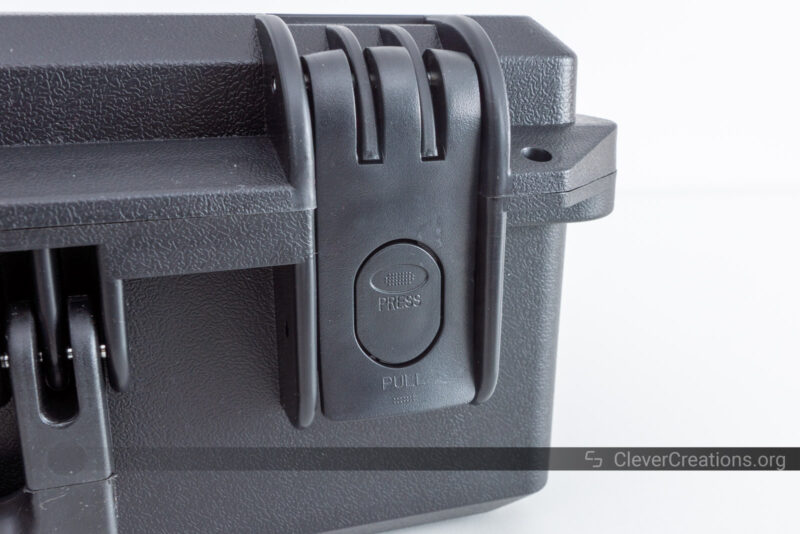 A close-up of the latch on a black Pelican-style case
