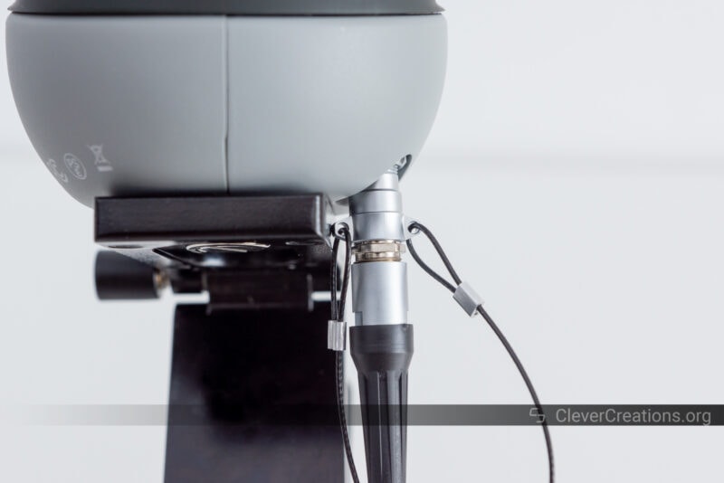 A close-up of a 3D scanner connector interfering with its mounting point on a tripod.