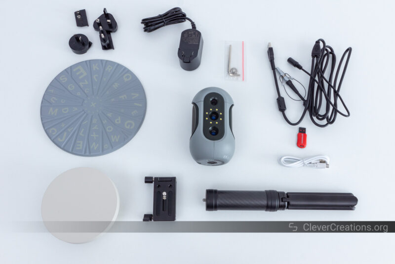 The 3DMakerPro Mole with cables, turntable, tripod, and power adapter on a white surface
