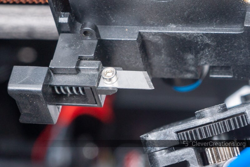 Close-up of a filament cutting blade in a 3D printer print head