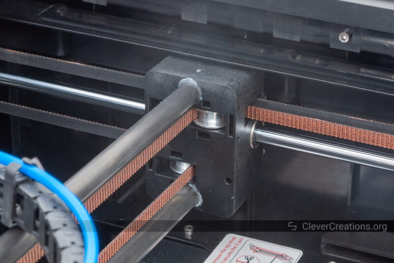 Two carbon fiber X-axis rods epoxied to a Y-axis carriage on a CoreXY machine