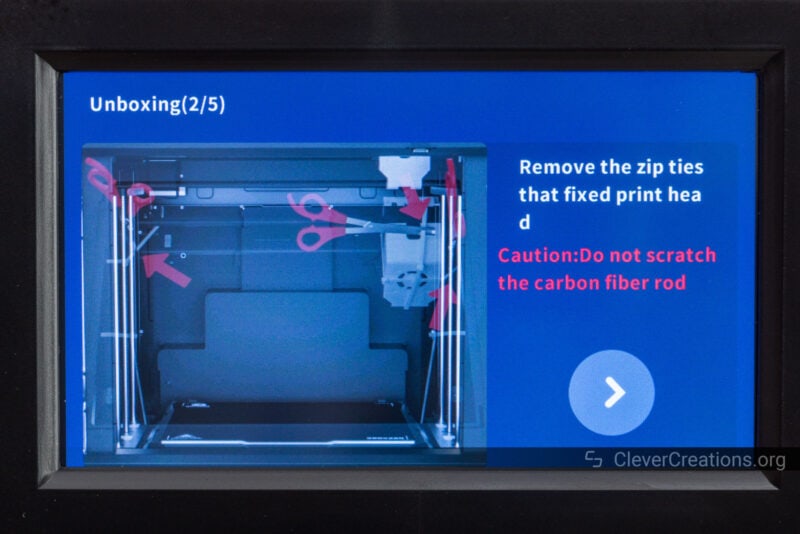 A 3D printer LCD screen with unboxing instructions displayed