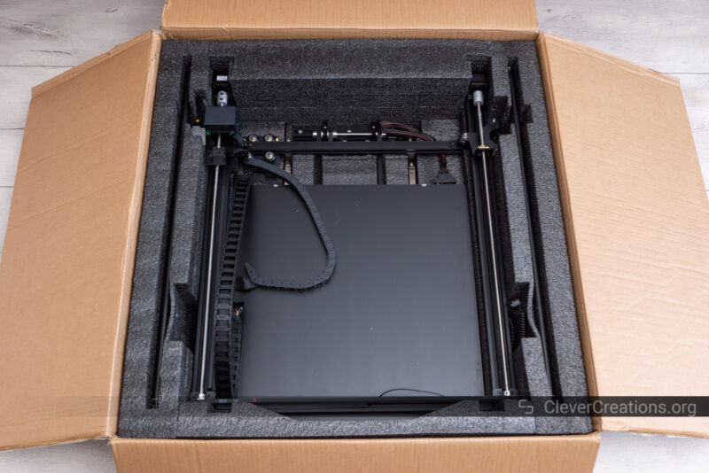 Various 3D printer components inside a foam-padded box