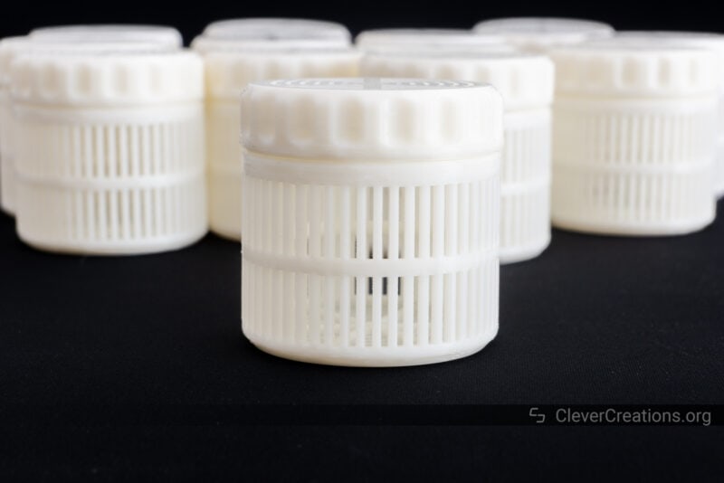 A collection of white 3D printed dessicant containers