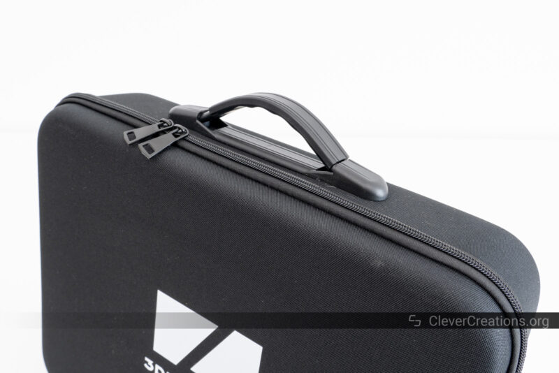 A black carrying case with zipper and handle