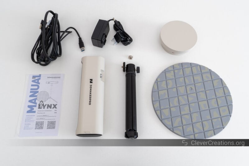 The Lynx 3D scanner and accessories laid out on a white table during unboxing.