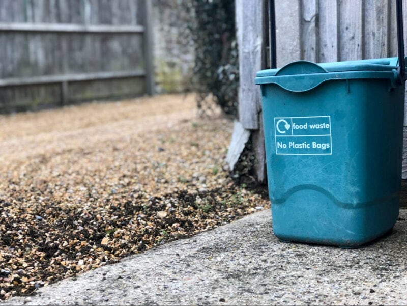 A small compost bin labeled 'Food waste - No plastic bags'