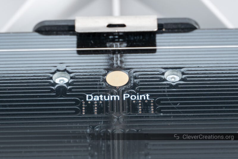 A datum point on a heated bed PCB that can be used for leveling