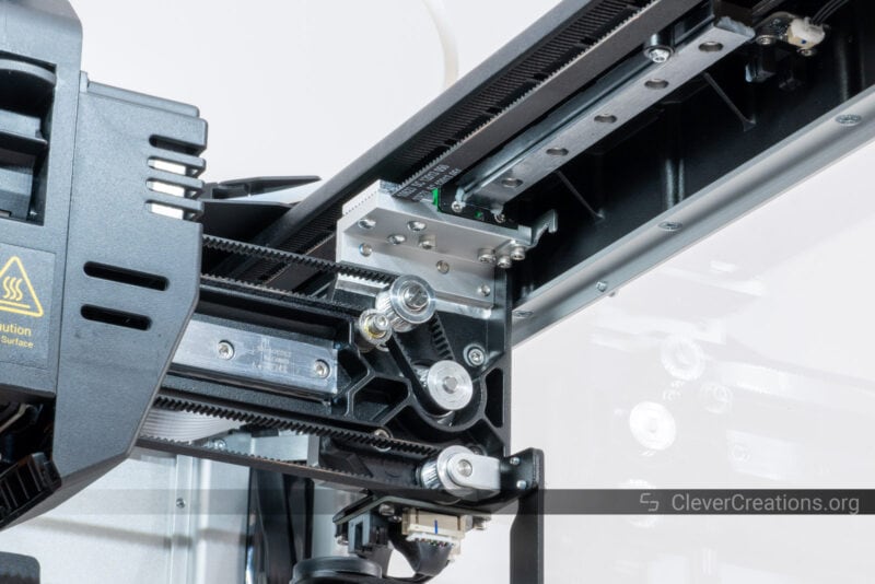A close-up of the all-metal construction of a dual-extruder 3D printer