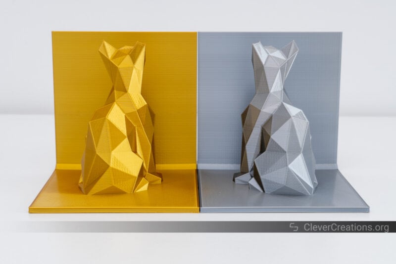 3D printed cat bookends in gold and silver