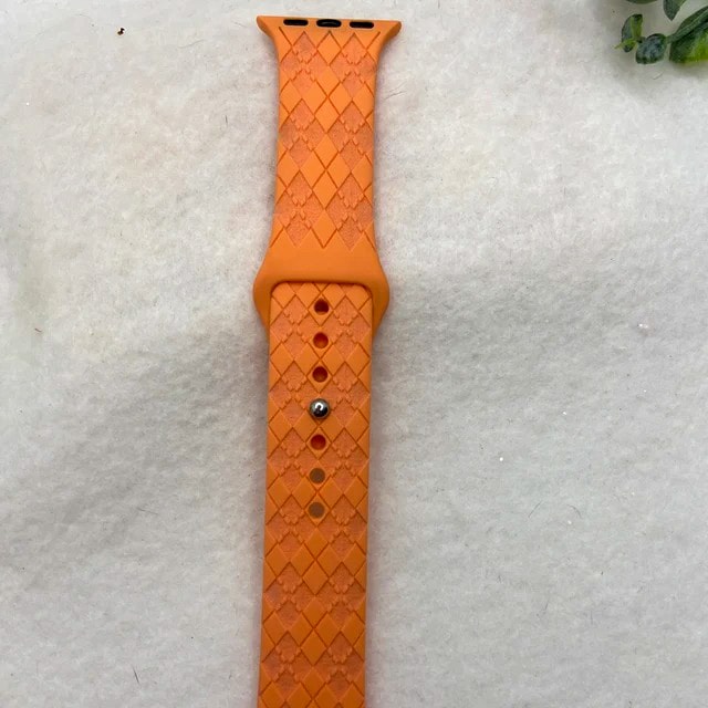 A custom orange laser etched Apple watch strap