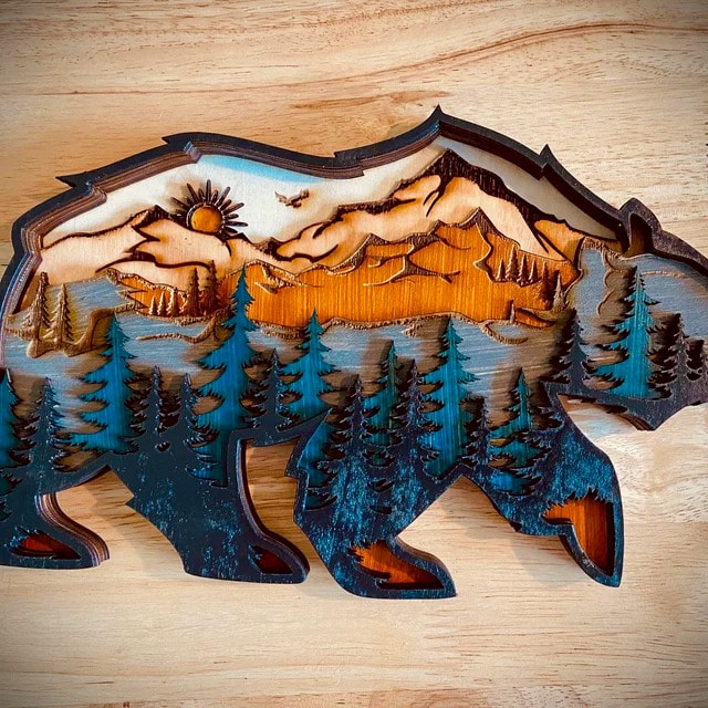 A multilayer wood Glowforge project with the outline of a bear