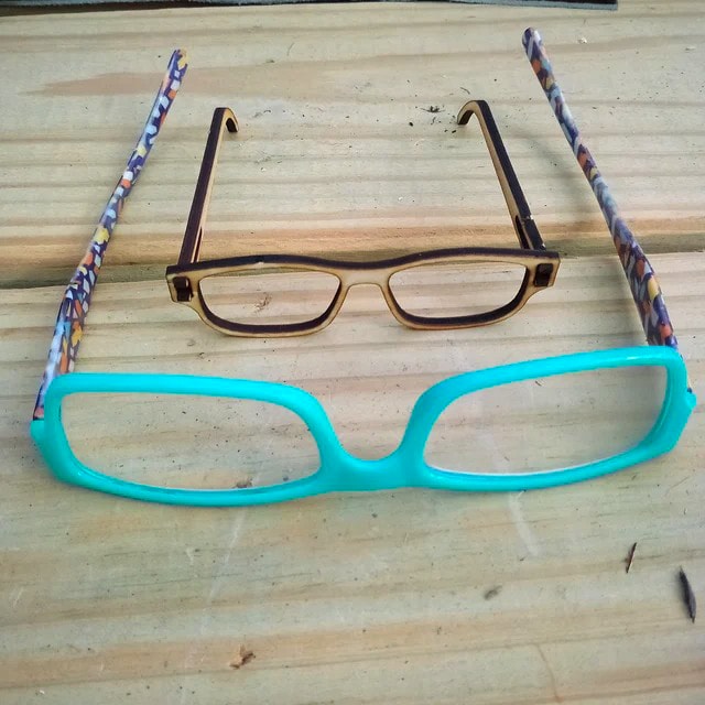 Laser cut eyeglasses next to a pair of regular eyeglasses