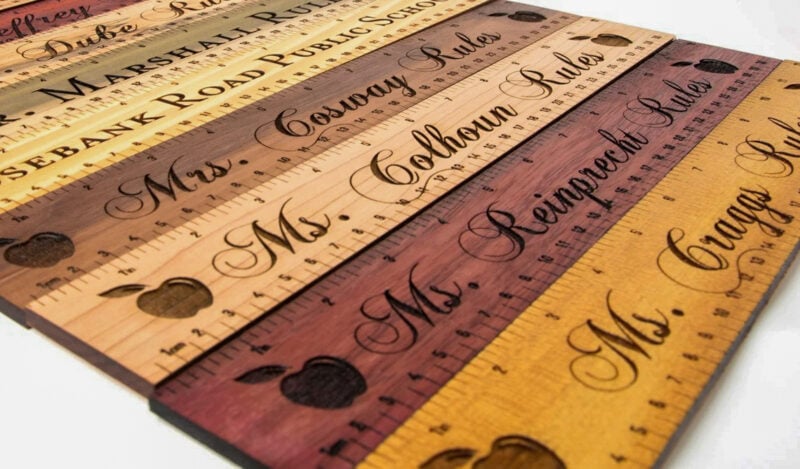 A collection of laser engraved rulers as a Glowforge project with various colors of wood