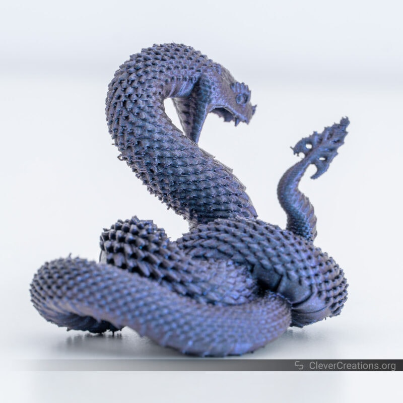 A 3D printed dragon in blue/purple PLA filament