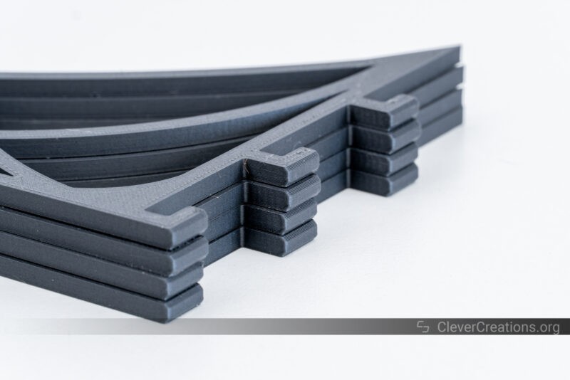 Four black PLA-CF 3D prints of a shelf support