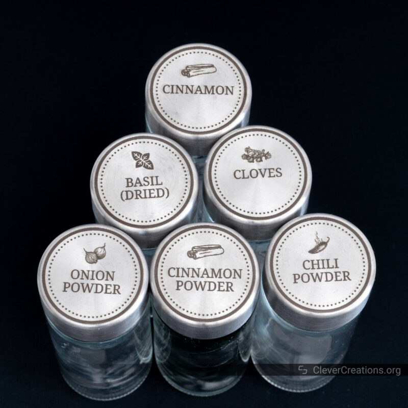 A set of spice jars with engraved stainless steel lids