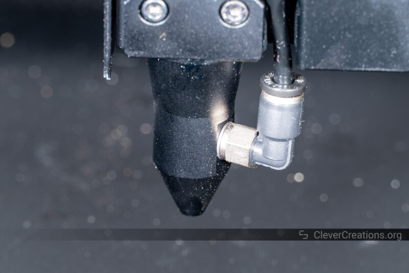 A close-up of a laser cutter's air assist nozzle