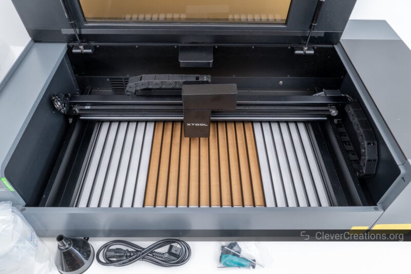 A large CO2 laser cutter with opened lid in the process of unboxing