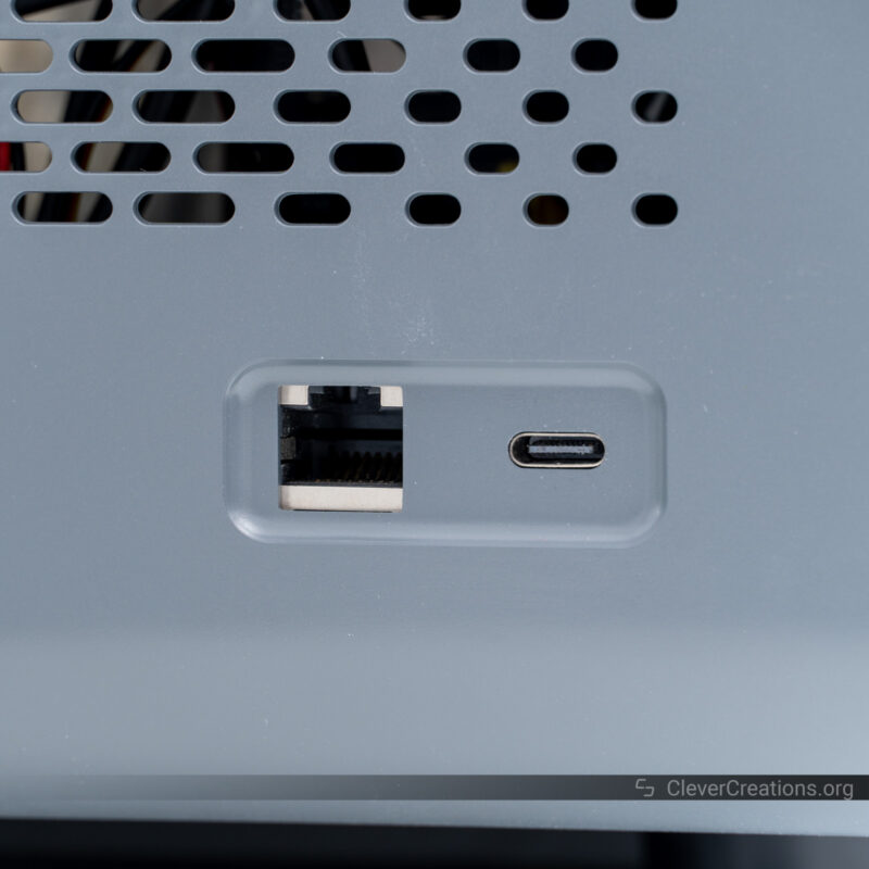 A USB Type-C port and an Ethernet port on a plastic side panel of a device