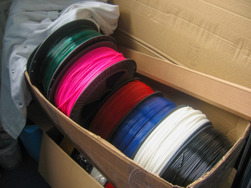 Several carton boxes with ABS alternative filaments in different colors.