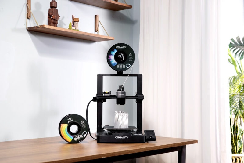 The Ender-3 V3 SE printer and several spools of filament in a home environment.