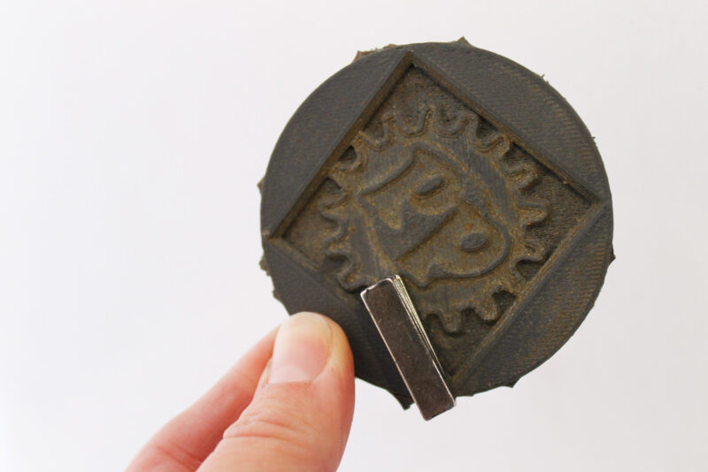 A magnetic 3D print with a magnet attached to it.
