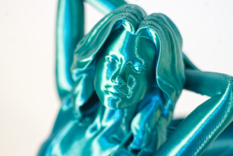 A model 3D printed in teal shiny silk material
