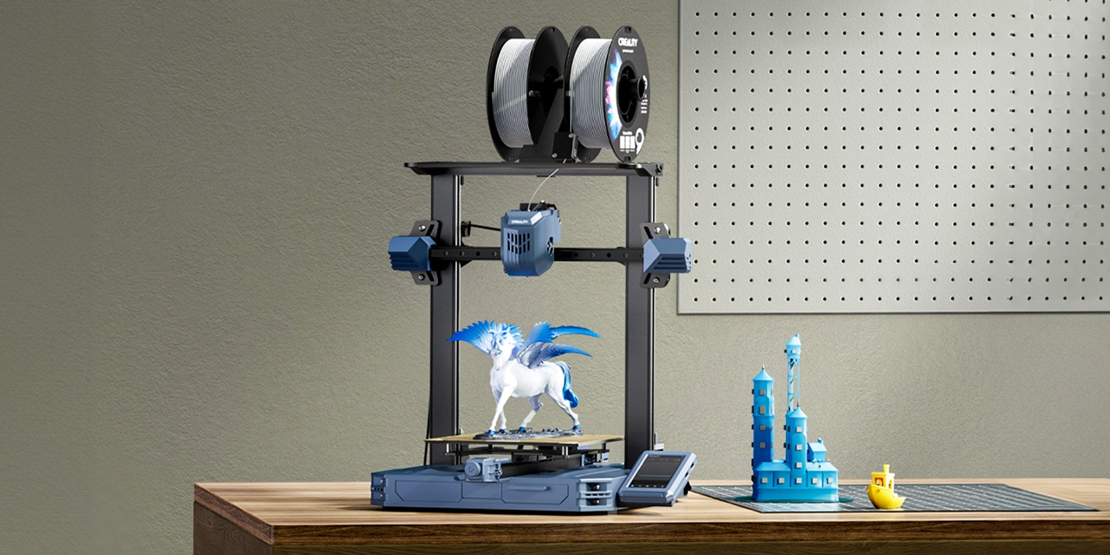 The Creality CR-10 SE 3D printer on a workbench next to several 3D prints.