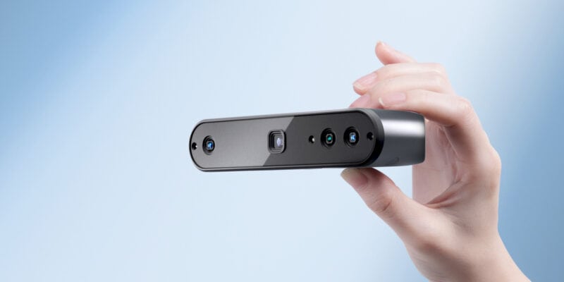 A hand holding the new Revopoint INSPIRE 3D scanner