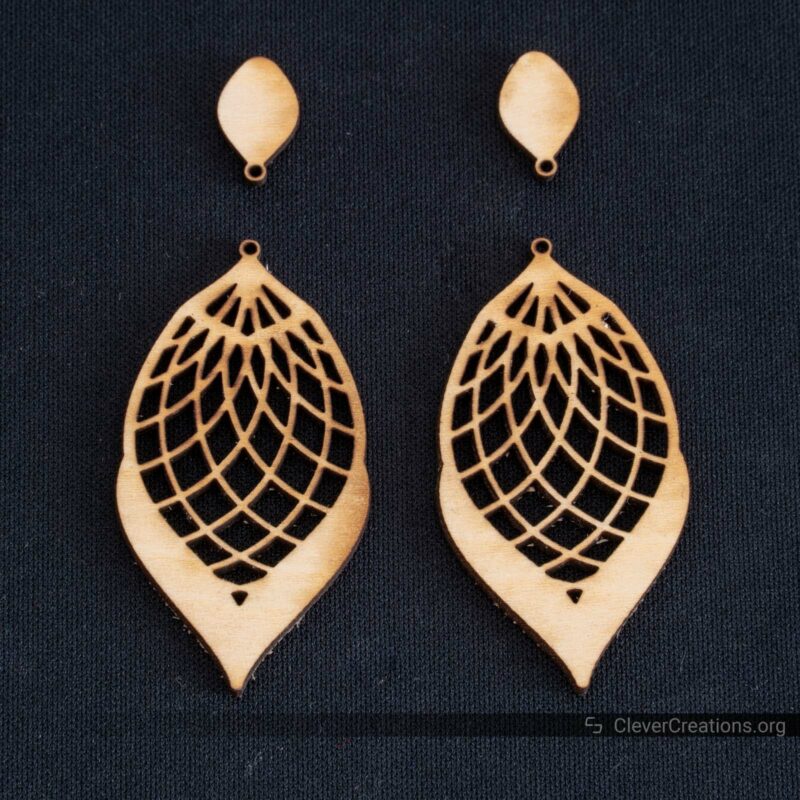 Laser cut earrings with mild scorch marks from a lack of air assist.