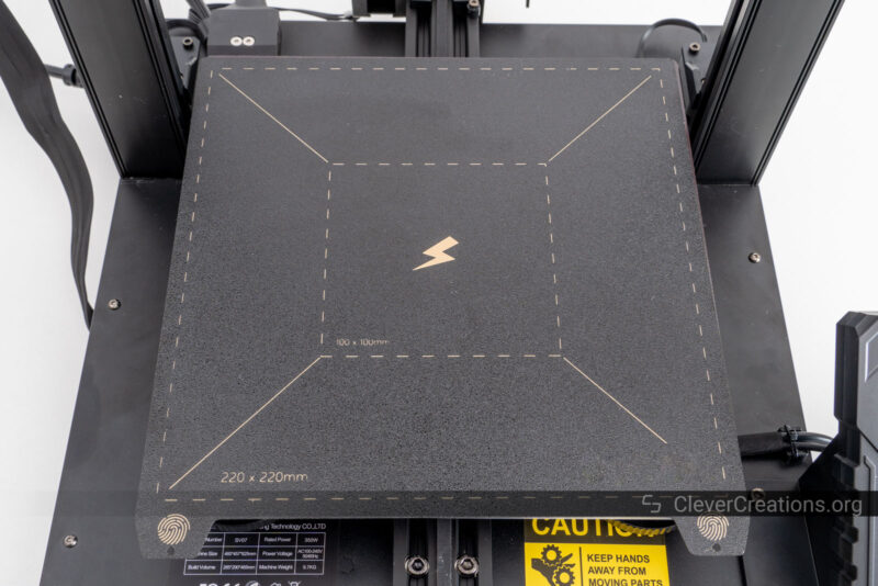 A top-view of a black empty 3D printer bed.