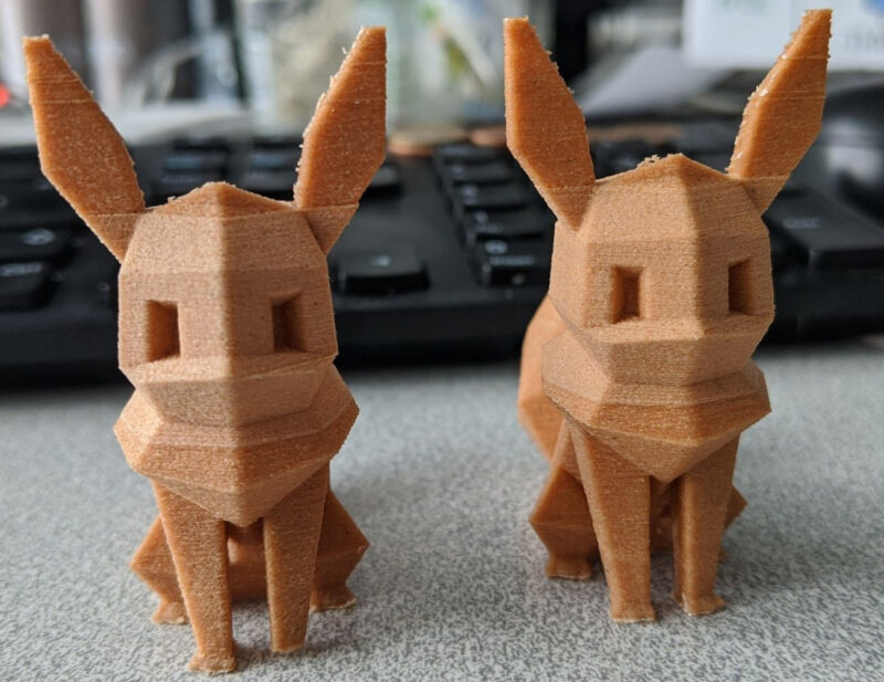 Two 3D-printed low-poly Eevee models made with wood-filled PLA filament.