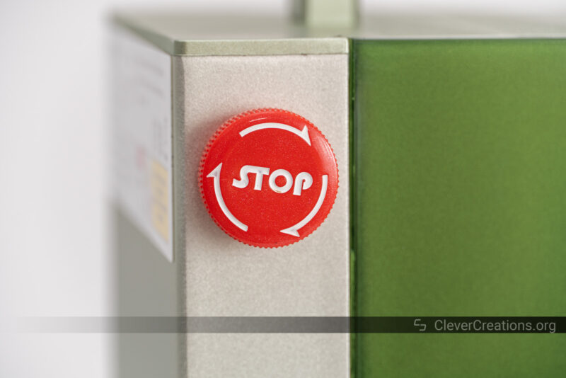 A close-up of the emergency button on a laser cutter and engraver.