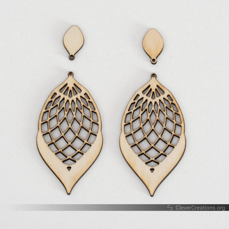 A pair of laser cut earrings with slight burn marks made with the xTool F1.