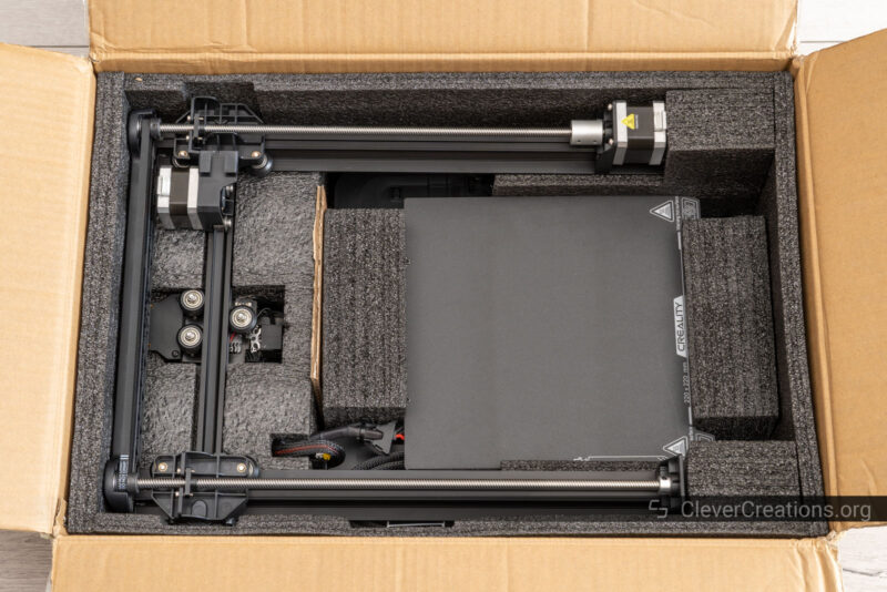 The Creality Ender-3 V3 SE in foam inside of its shipping box.