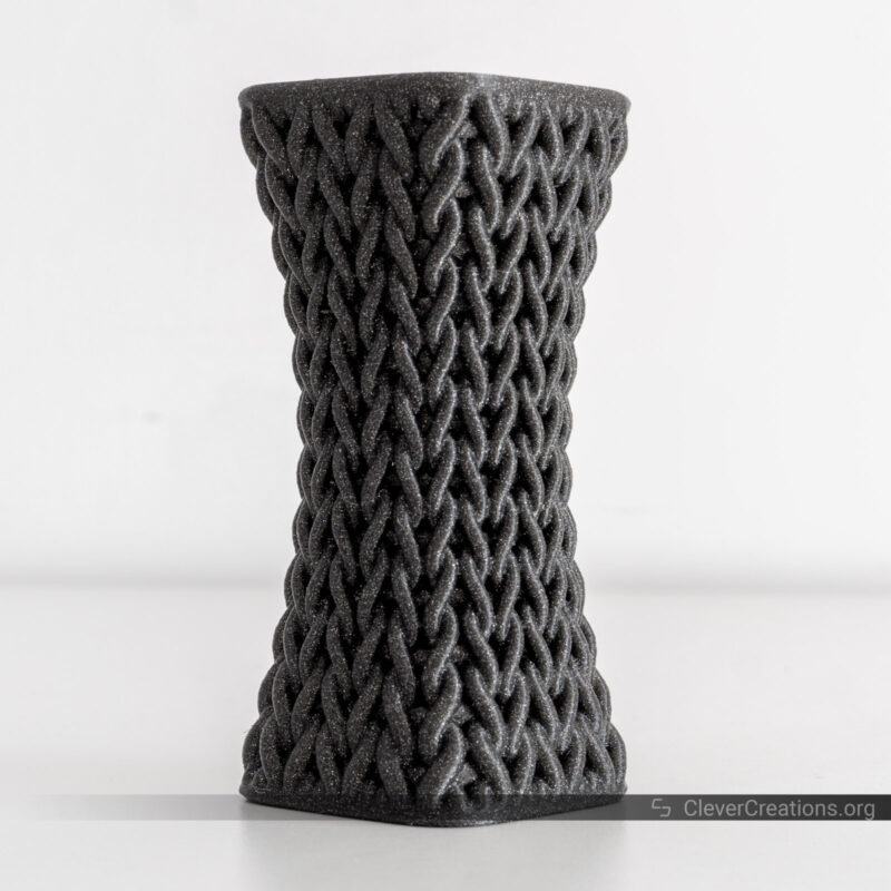 A 3D printed black glitter knotted vase