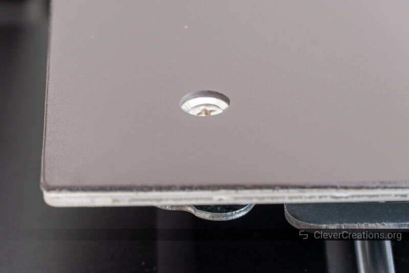 A Phillips-head screw used to hold a heated print bed in place.