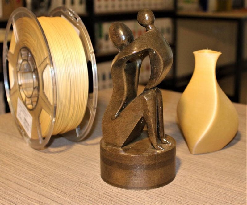 A shiny and polished wooden statuette that was made with a 3D printer.