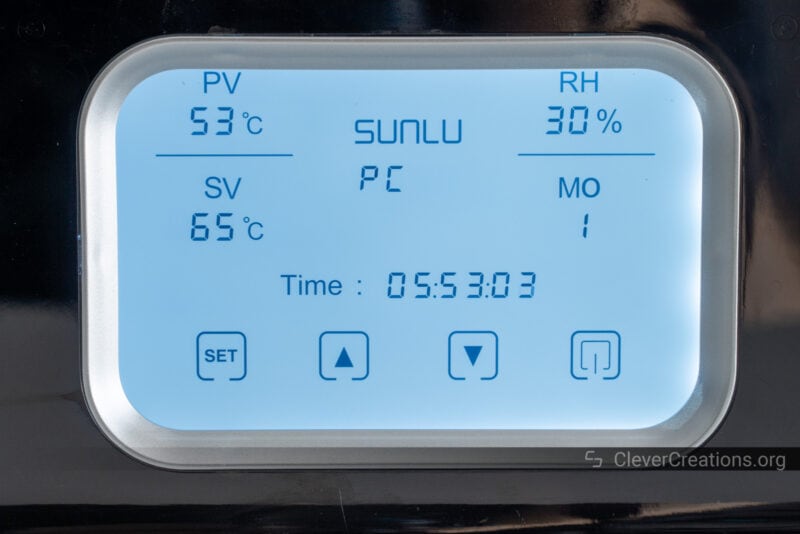 An LCD interface screen on a SUNLU filament dryer.