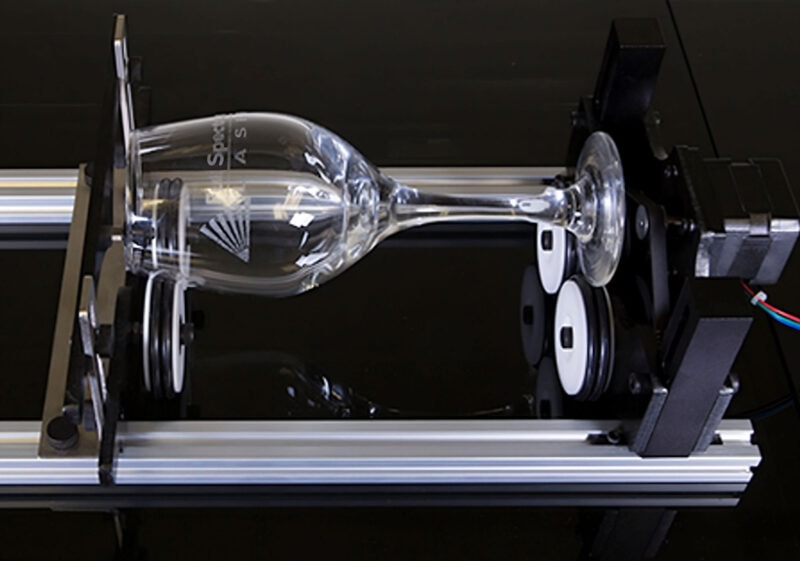 A rotary engraving tool for a Muse laser engraving machine used to engrave a wine glass.