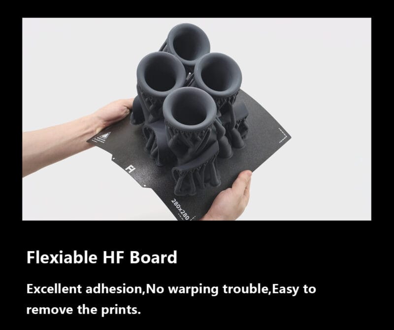 Two hands bending a flexible HF printing plate with a CF 3D print on it.