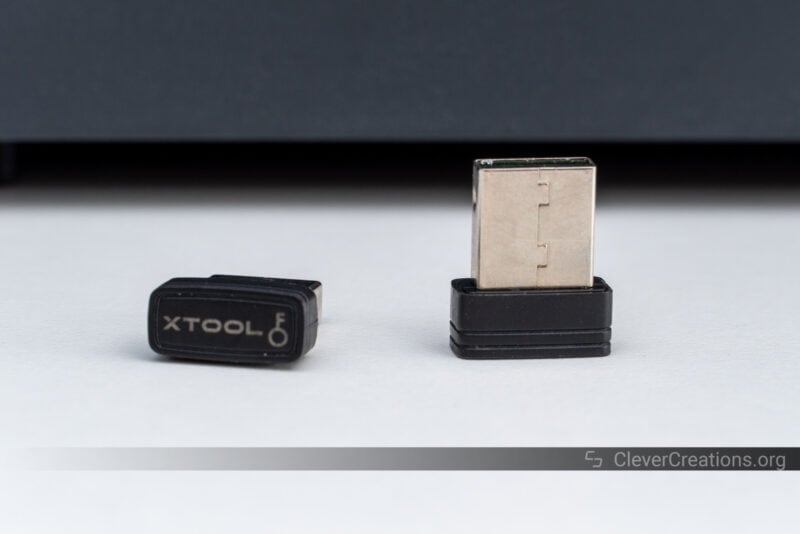 Two small USB keys that are used to lock unauthorized access to the xTool S1.