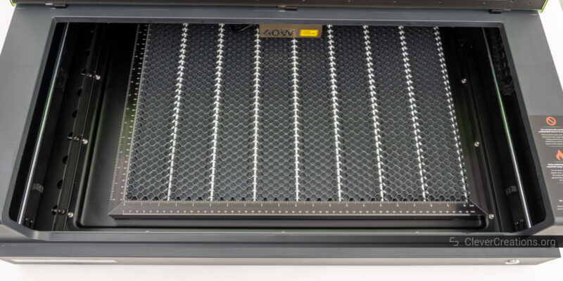 A honeycomb panel placed inside of the xTool S1 work area.