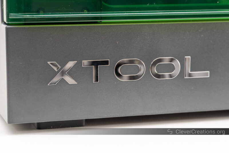 A close-up of the metallic xTool logo on front of the S1 laser machine.