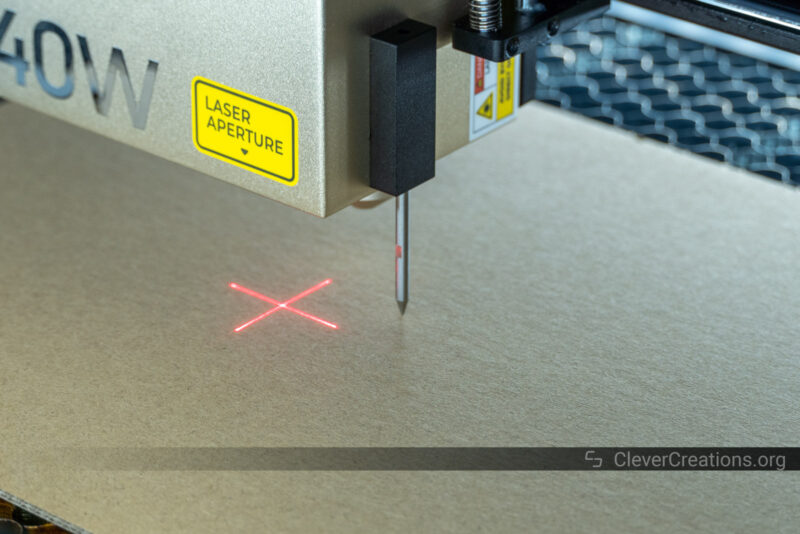 A magnetic touch probe on a laser head touching the surface of a workpiece.
