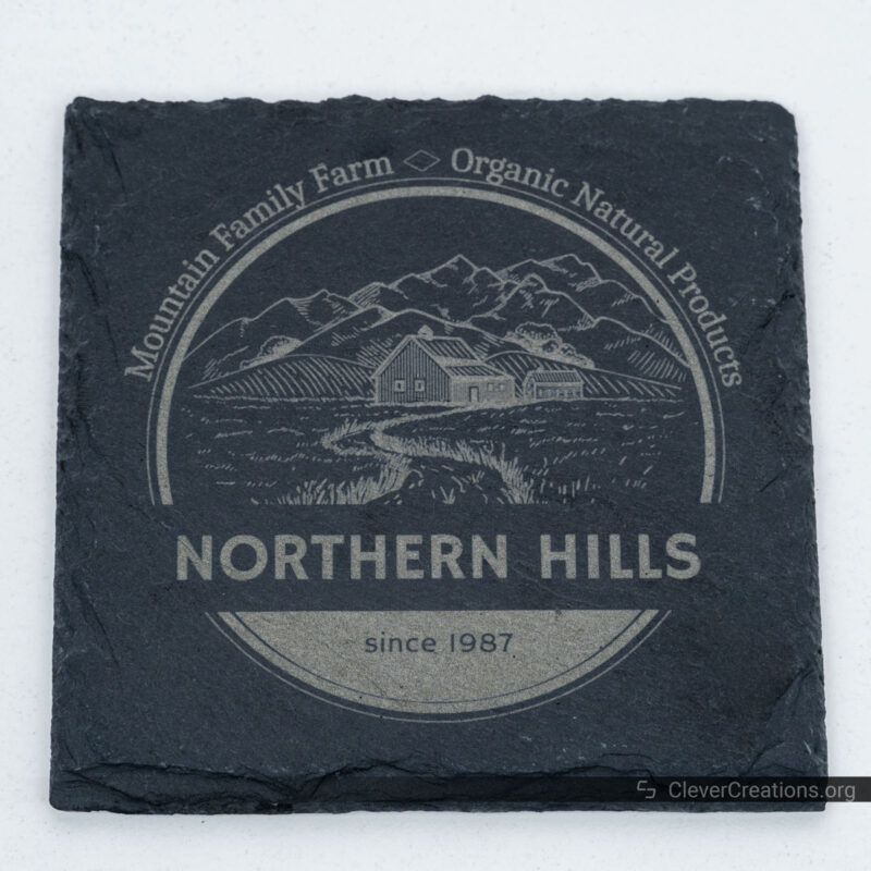 A stone coaster with engraved logo from 'Northern Hills' Mountain Family Farm.