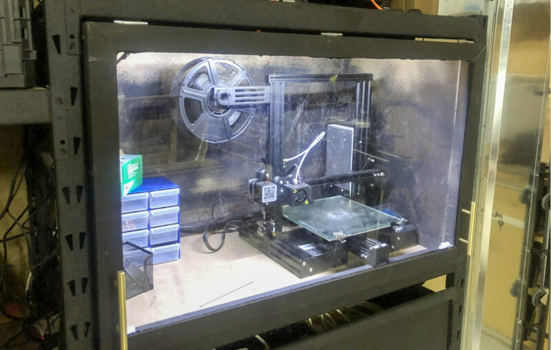 A 3D printer in an enclosure to help prevent prints warping mid print.