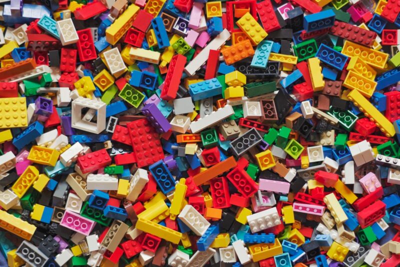A pile of LEGO bricks in various colors and shapes.
