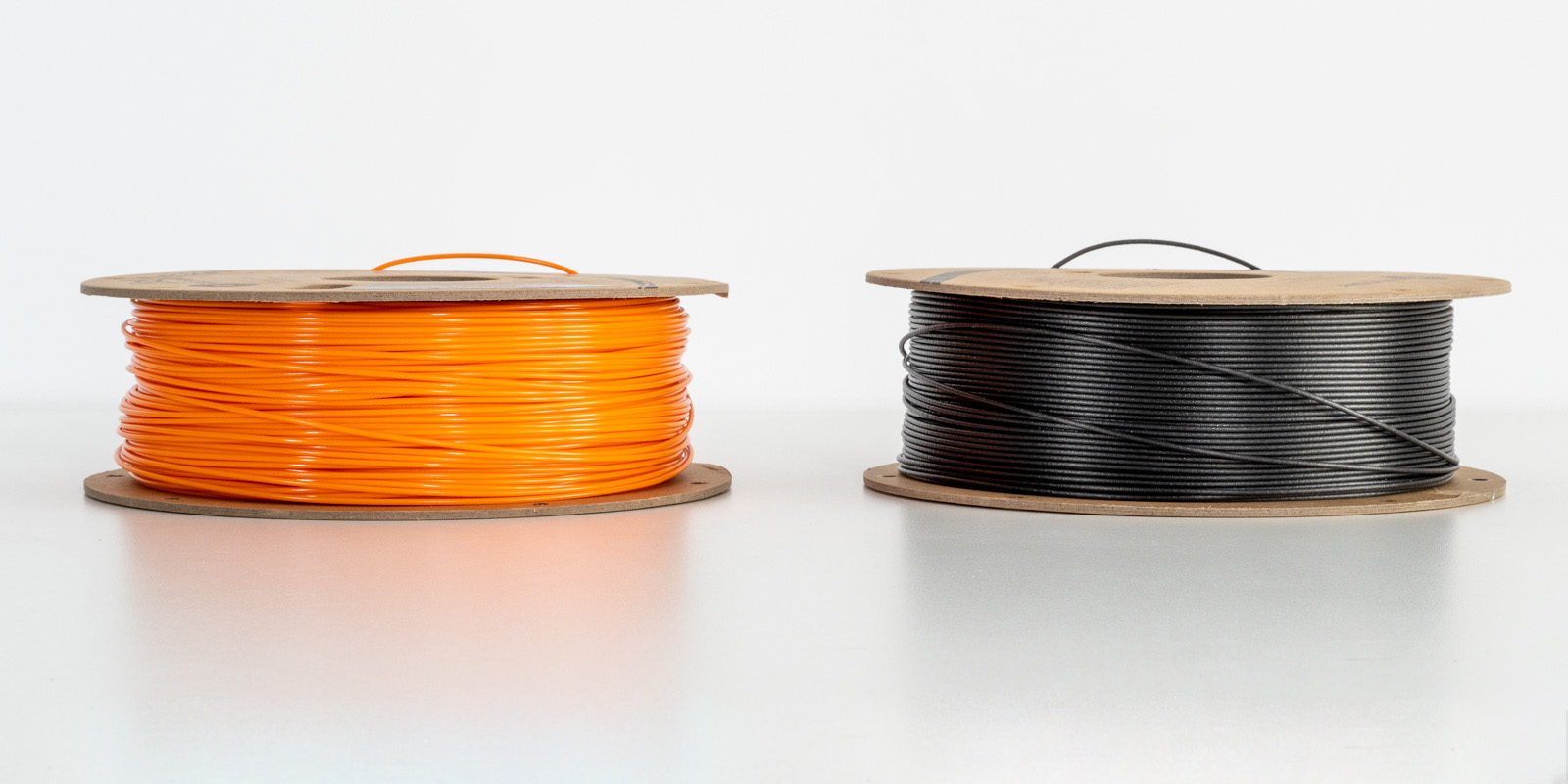 A side by side comparison of ASA vs ABS plastic filament for 3D printing.